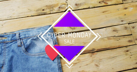Image of cyber monda sale text over denim trousers on wooden background