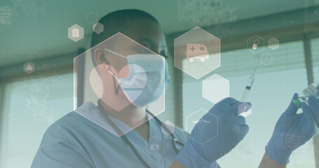 Image of medical icons over african american female doctor wearing face mask - Powered by Adobe