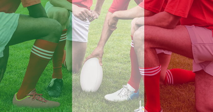 Golden confetti and italy waving flag against group of male rugby players on a sports field - Powered by Adobe