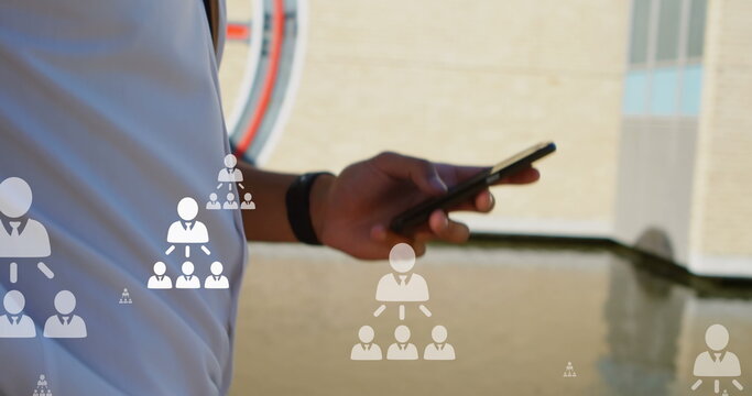 Image of user icons over hands of biracial man using smartphone in city - Powered by Adobe