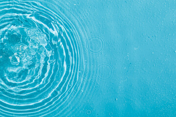 drops on water with circles on a blue background