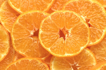 juicy and appetizing tangerines cut into circles as a food background 6