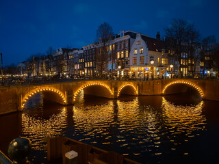 Bridges illuminated at night on the Keizersgracht canal in Amsterdam in winter