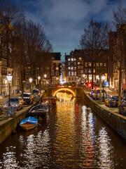 Bridge illuminated at night on the Langestraat canal in Amsterdam in winter