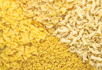 Background of different pasta types. Concept of culinary, food backgrounds. The view from the top.