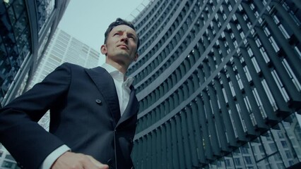 Elegant Handsome Business Man In Black Suit Standing Outdoors Taking Off His Glasses, Cinematic Low Angle - Powered by Adobe