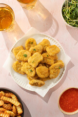 Fast food chicken nuggets paired with a glass of apple juice
