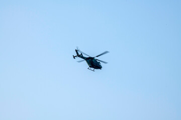 helicopter flying on isolated blue sky