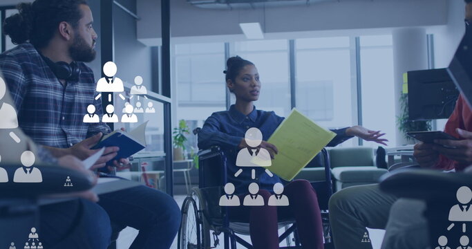 Image of social media icons over diverse businesspeople working in office