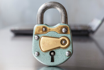 Cybersecurity concept, closed padlock with laptop computer in background - 757938426