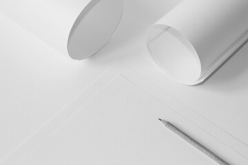 Monochrome Design Studio Mockup. Sheets of Paper, Graphite Pencil, Paper Rolls Arrangement on...