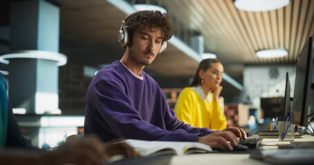 Portrait of a Smart Male Working on a Computer with a Group of University Students. Young Man...