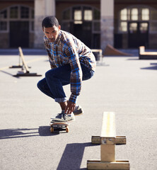Man, skateboard and riding at urban skatepark, sports and energy with skill, stunt and recreation...