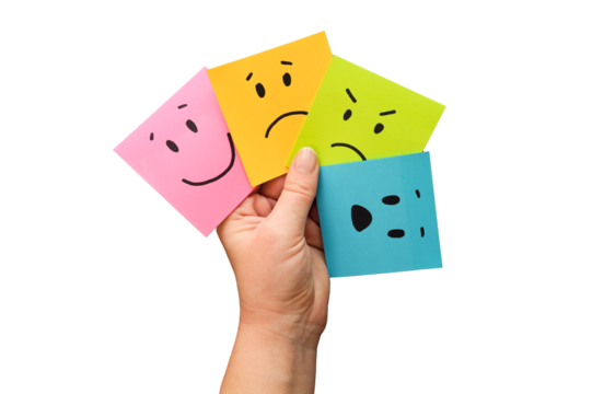 Hand holds notes with a basic emotions - joy, sadness, anger, fear or surprise. Four colorful squares with emotions on a transparent background