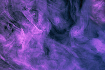 Purple with shades of blue smoke on a dark black background. Beautiful abstract colored background.