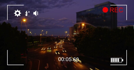 Image of night traffic in fast motion, seen on a screen of a digital camera in record mode with icon