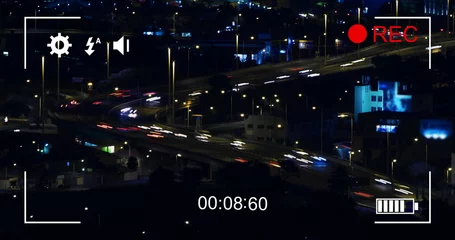 Foto op Plexiglas Digital camera records fast-moving night traffic and cityscape in 4k. © vectorfusionart