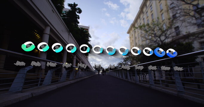 Image of calendar graph processing data over fast speed pedestrians on city bridge