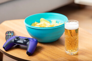Beer and chips on the coffee table. Preparing to watch something interesting on TV