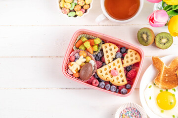 Cute Easter style lunchbox. Creative kids school lunch box with Easter symbols and sweets - bunny...