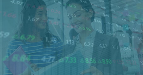 Image of financial data over diverse female lcoworkers in office