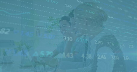 Image of financial data over diverse female lcoworkers in office