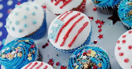 Fotobehang Image of usa flags and white and red stripes over cupcakes © vectorfusionart