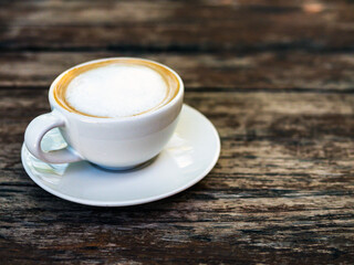 Hot cappuccino cup on wooden table