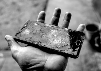 Broken smartphone in human hand