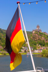 German flag flutters against the background of Reichsburg castle, Cochem, Germany - 757970288