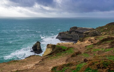 Dark cliffs and ruins of an abbey in Brittany