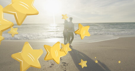 Image of stars over biracial couple at beach