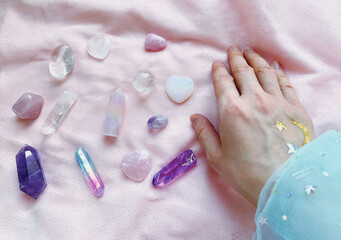beautiful esoteric magical background. the magician's hand holds, selects the necessary crystals...