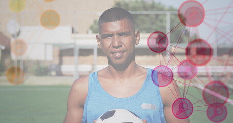Image of networks of connections over football player with ball