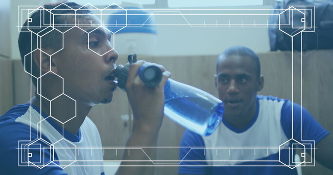 Image of white frame with markers over football players during break in changing rooms