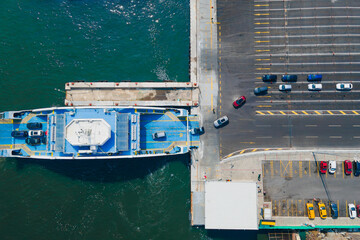 Ferryboat boarding cars on deck for transferring vehicles. Ferry transfers cars and passengers to...