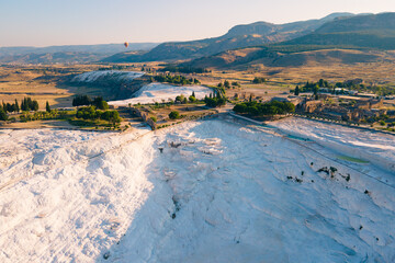 Aerial view of the travertines in Pamukkale, Turkey. White limestone mineral formations. Slider shot