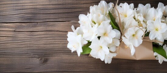 Elegant White Flower Bouquet Resting on Rustic Wooden Table - Serene Floral Arrangement