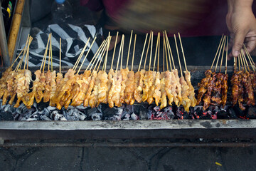 Chicken satay or called sate ayam served with peanut sauce and grilled for cooking process, one of...