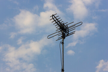 UHF Television antenna for catching channels, isolated on sky background
