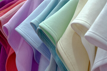Multi-colored tricot clothing in pastel colors - obrazy, fototapety, plakaty