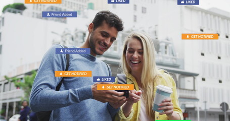 Image of social media icons floating over happy caucasian couple using smartphone