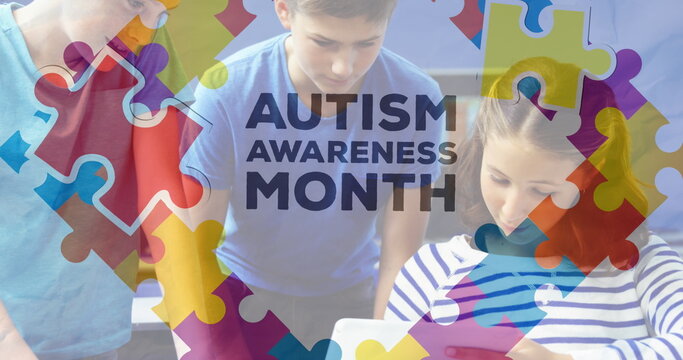 Image of autism awareness month text over diverse schoolchildren using tablet