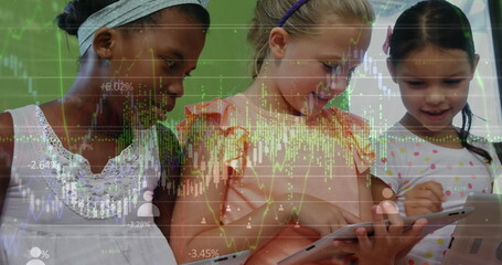 Image of graphs and financial data over diverse girls using tablet in classroom