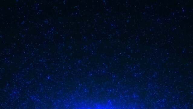 Shiny blue particles scatter glitter confetti on dark background. Motion graphic