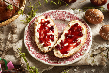 Two slices of traditional Czech sweet Easter cake called mazanec with butter and cranberry...