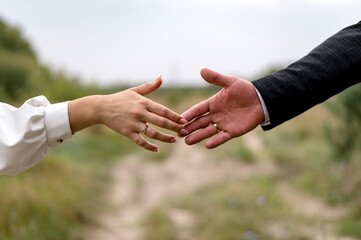 Hands of newlyweds with wedding rings