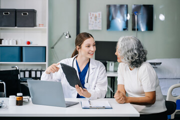 Obraz premium Portrait of female doctor explaining diagnosis to her patient. Doctor Meeting With Patient In Exam Room. A medical practitioner reassuring a patient .