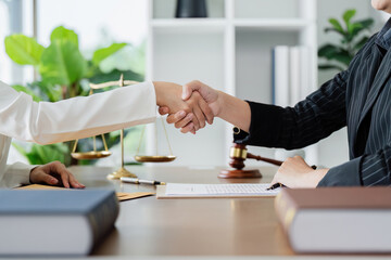 Lawyer handshake with a client making about documents, contracts, agreements, cooperation agreement