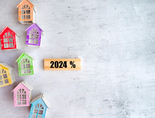 2024 housing market and property value concept with  small colorful houses .  Mortgage rates 